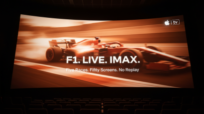 F1 race broadcast live in IMAX theater screen showing a Formula 1 car at speed during the 2026 season