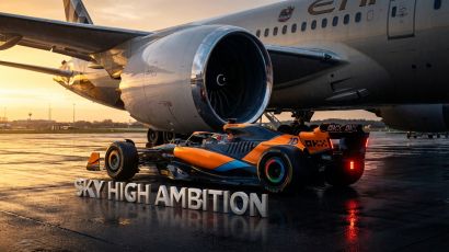 2026 McLaren F1 car under an Etihad Airways jet engine with championship typography.