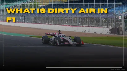 Formula 1 car following closely behind another through a corner losing downforce in dirty air turbulence